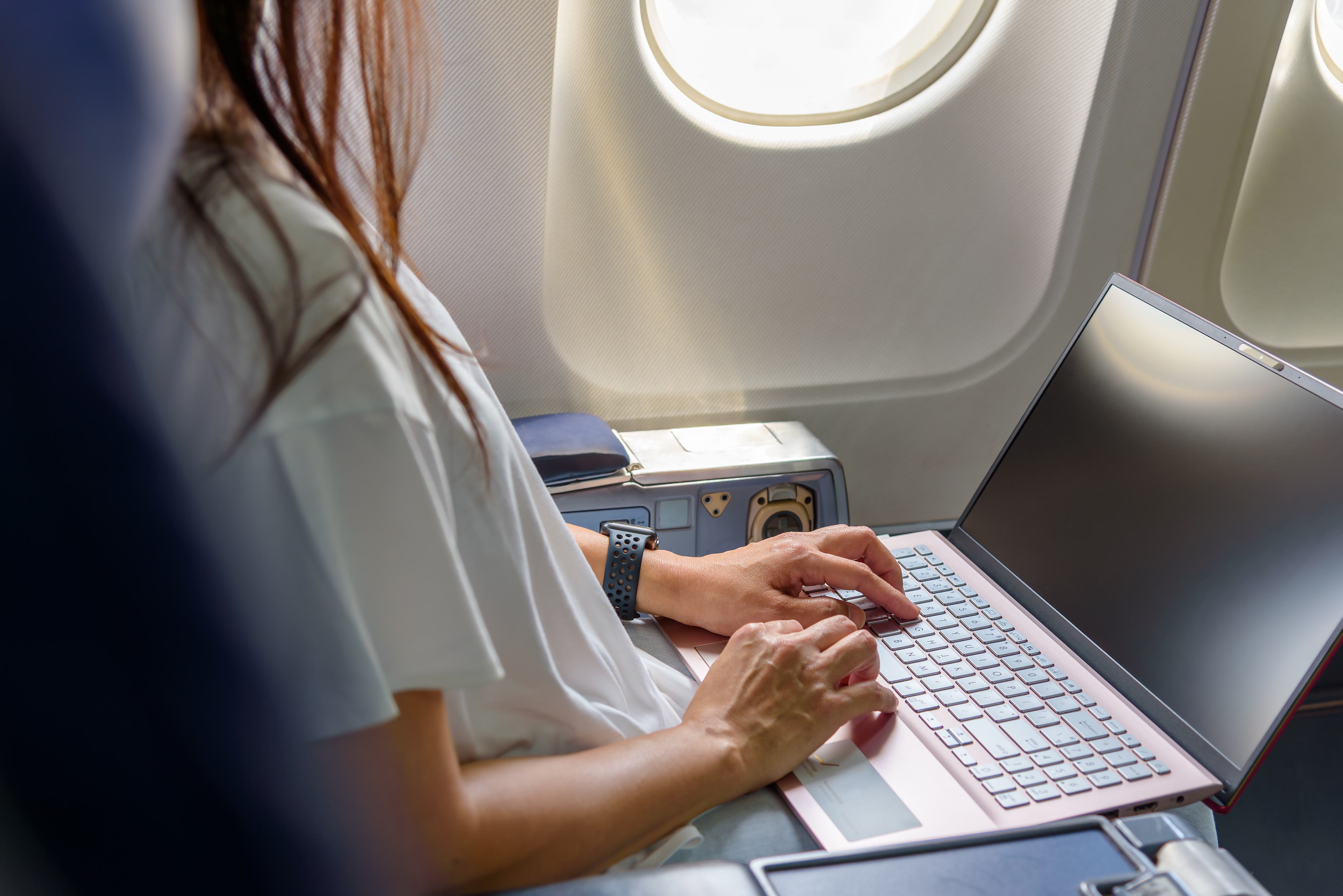 Working on Computer on Airplane