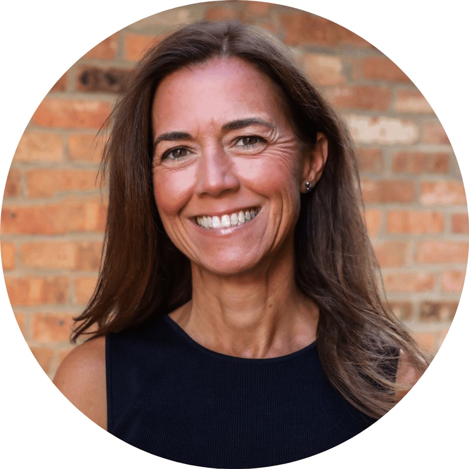 Colleen Olson's headshot with a brick wall in the background in a circular frame