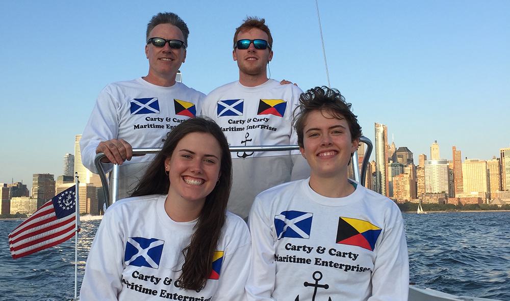 Dave Carty and his three children on a boat