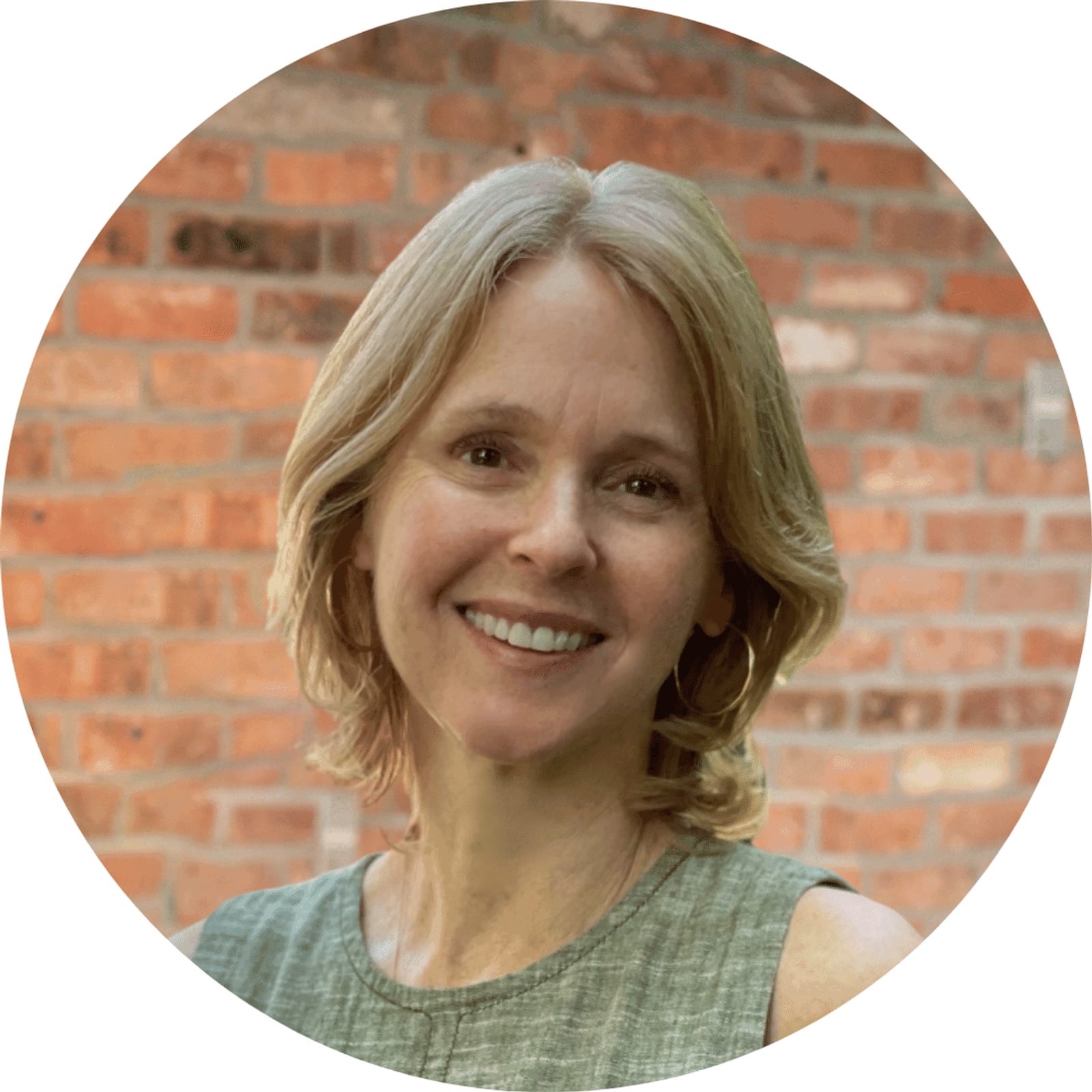 Elizabeth Gish's headshot with a brick wall in the background