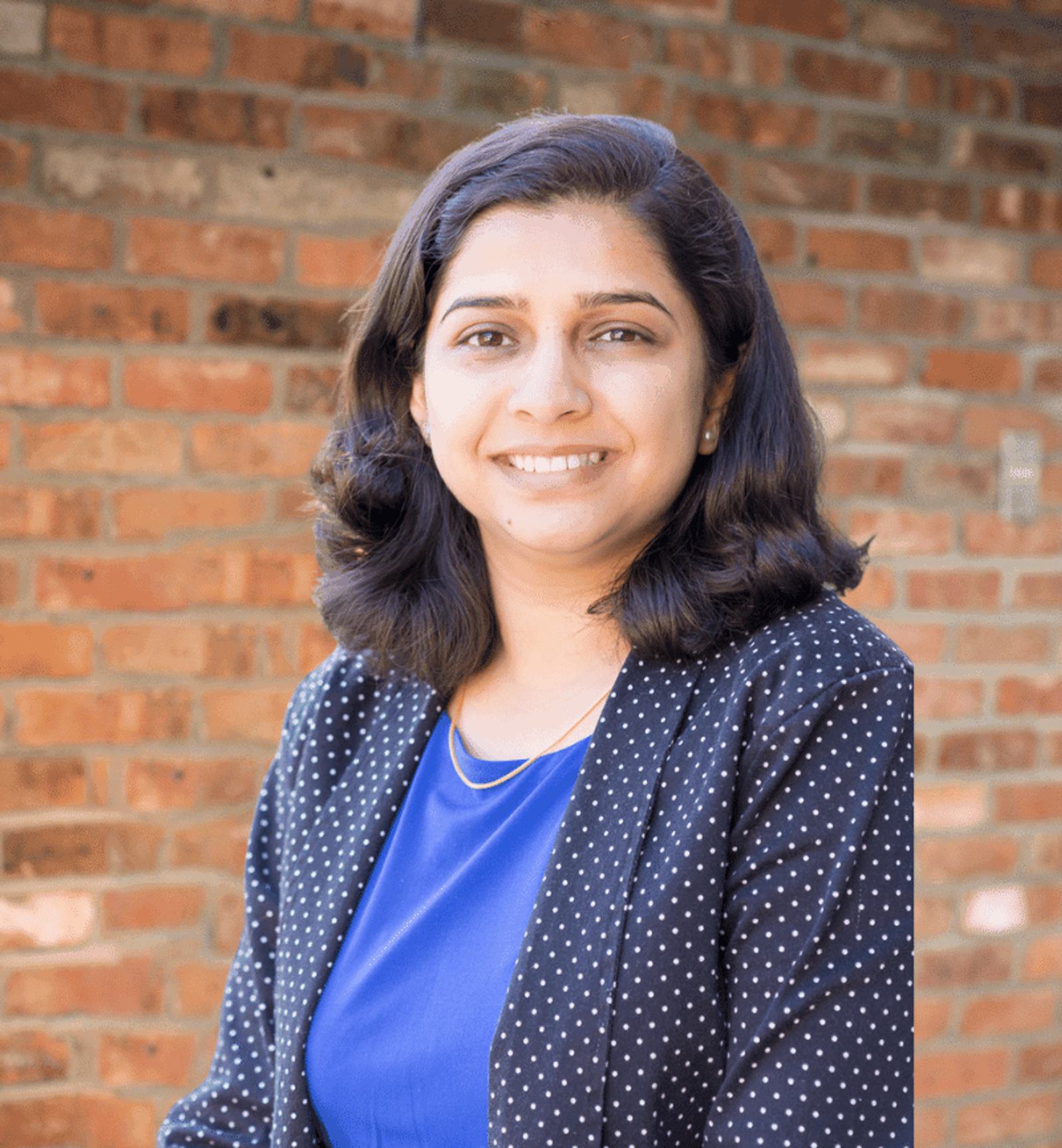 Rochna Pant's headshot with a brick wall in the background