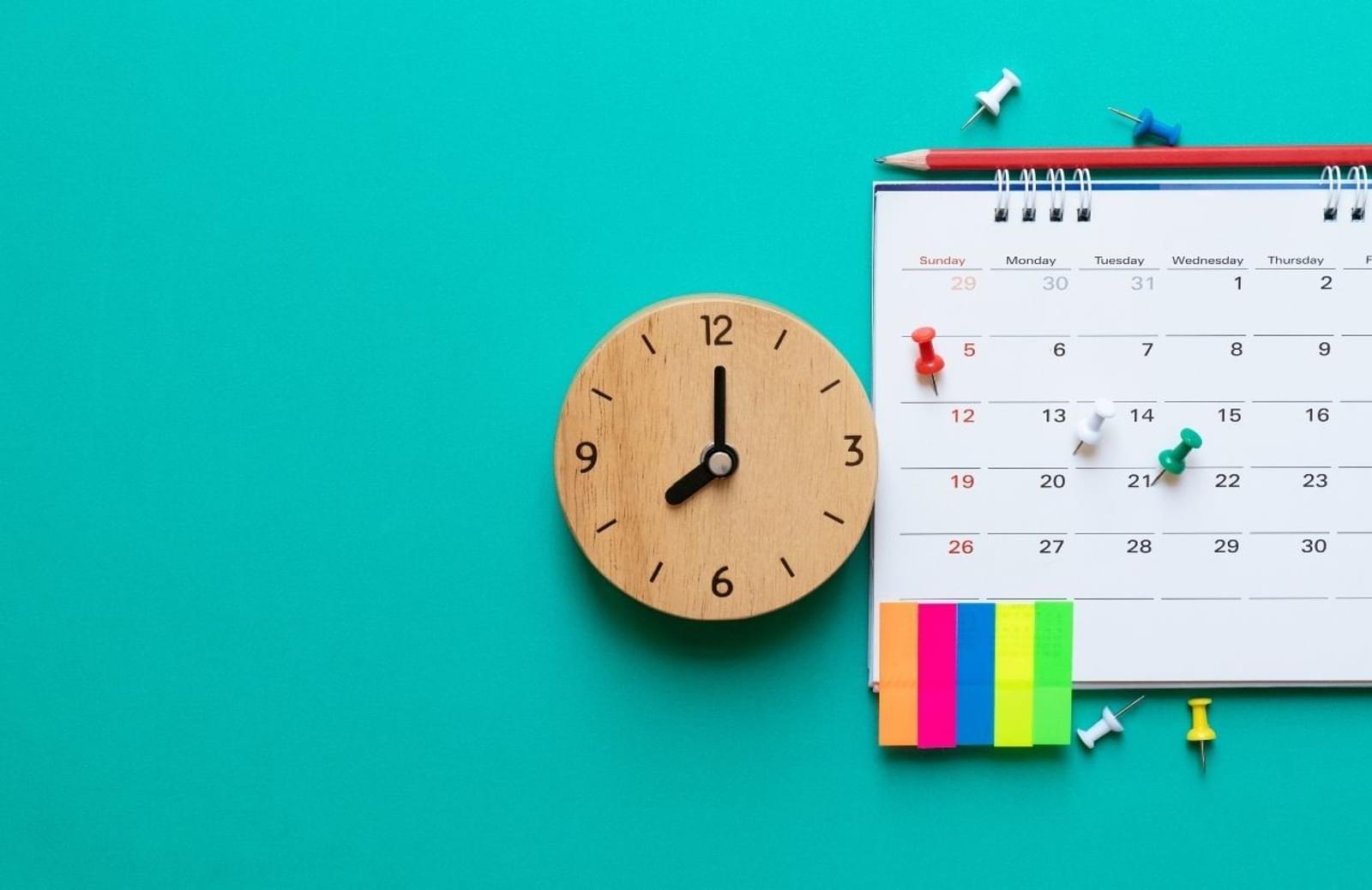 Clock, calendar, and post-it notes on a blue background
