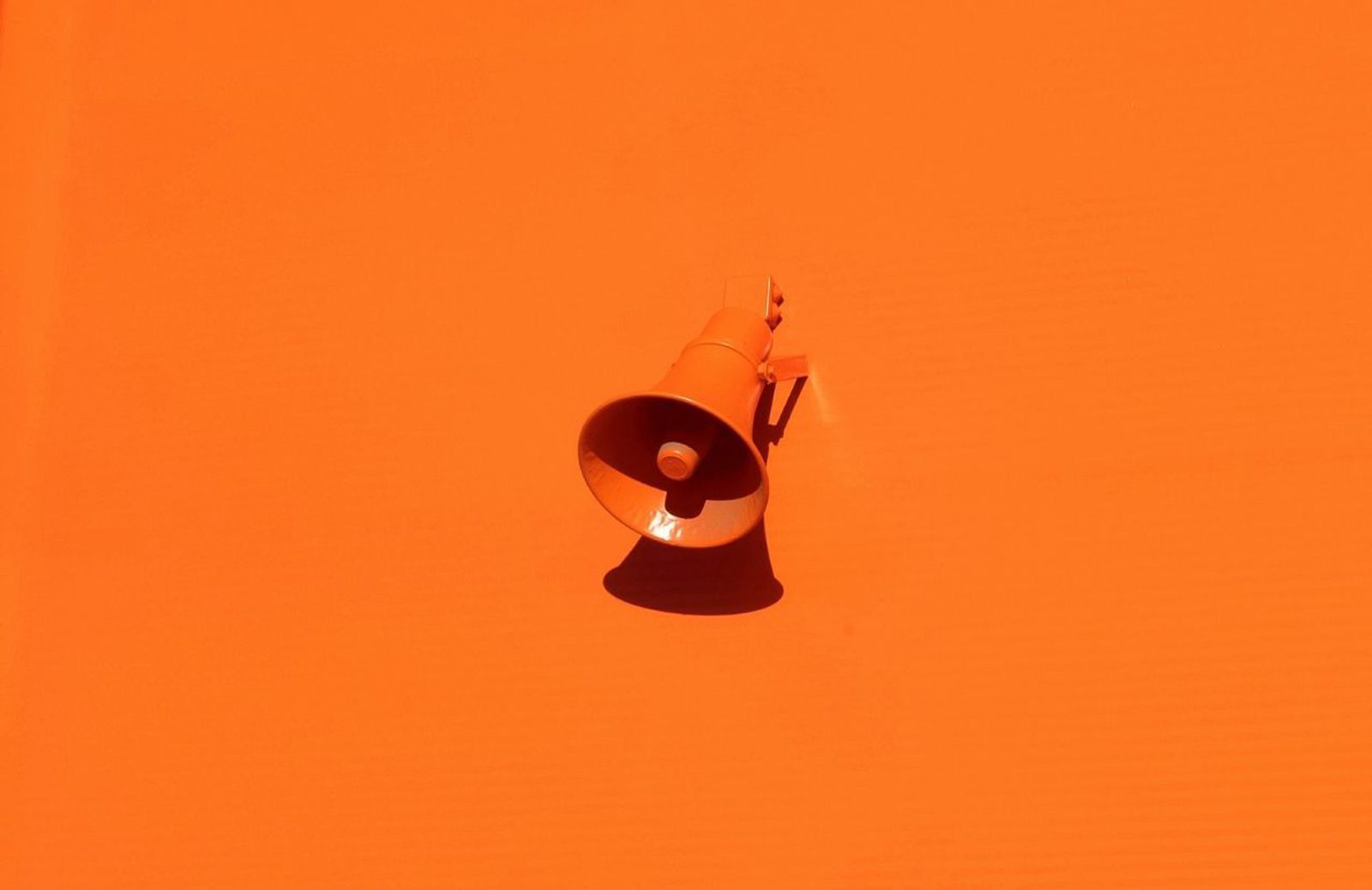 Megaphone against an orange background