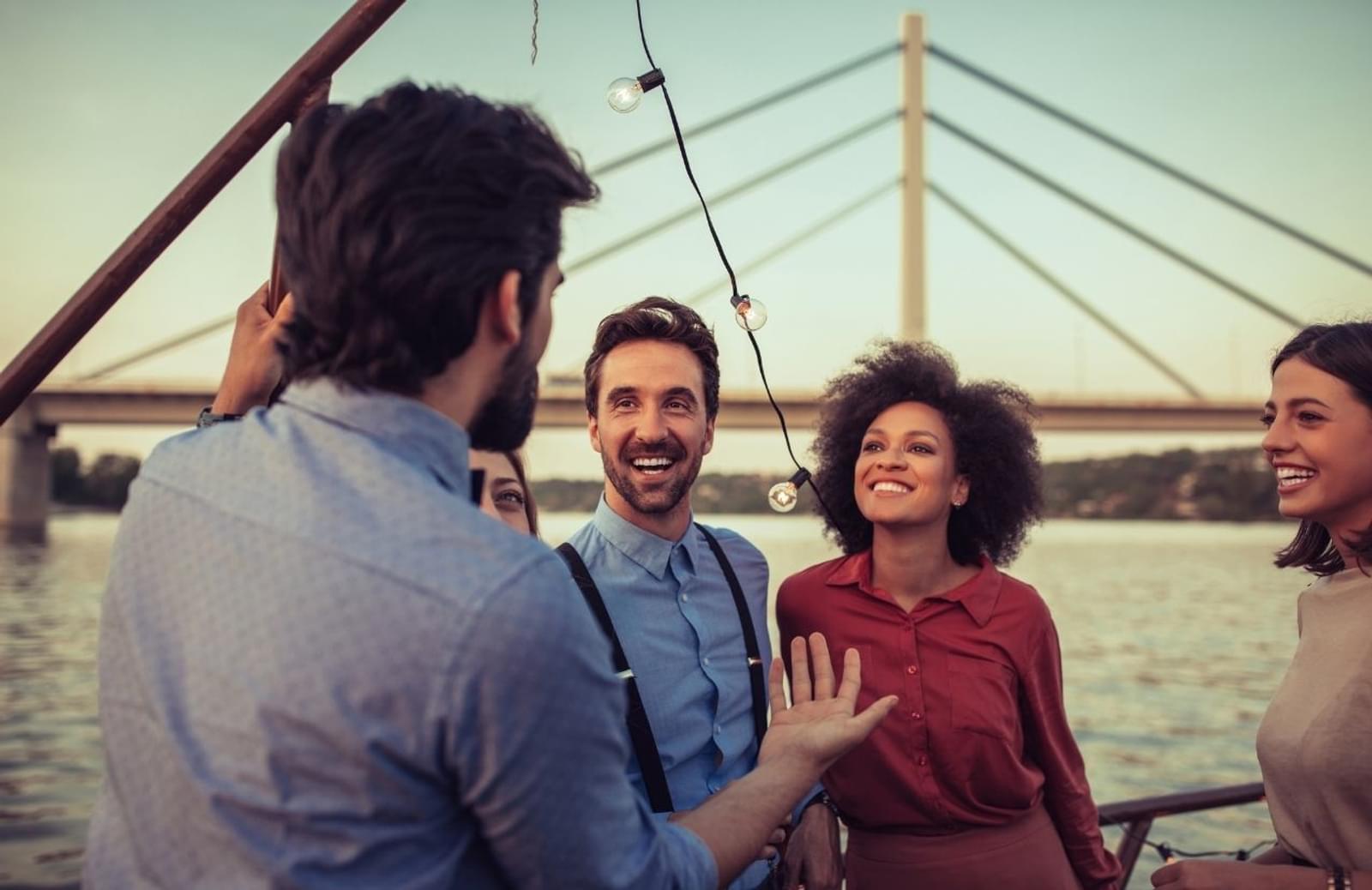 Four happy people talking on a bridge