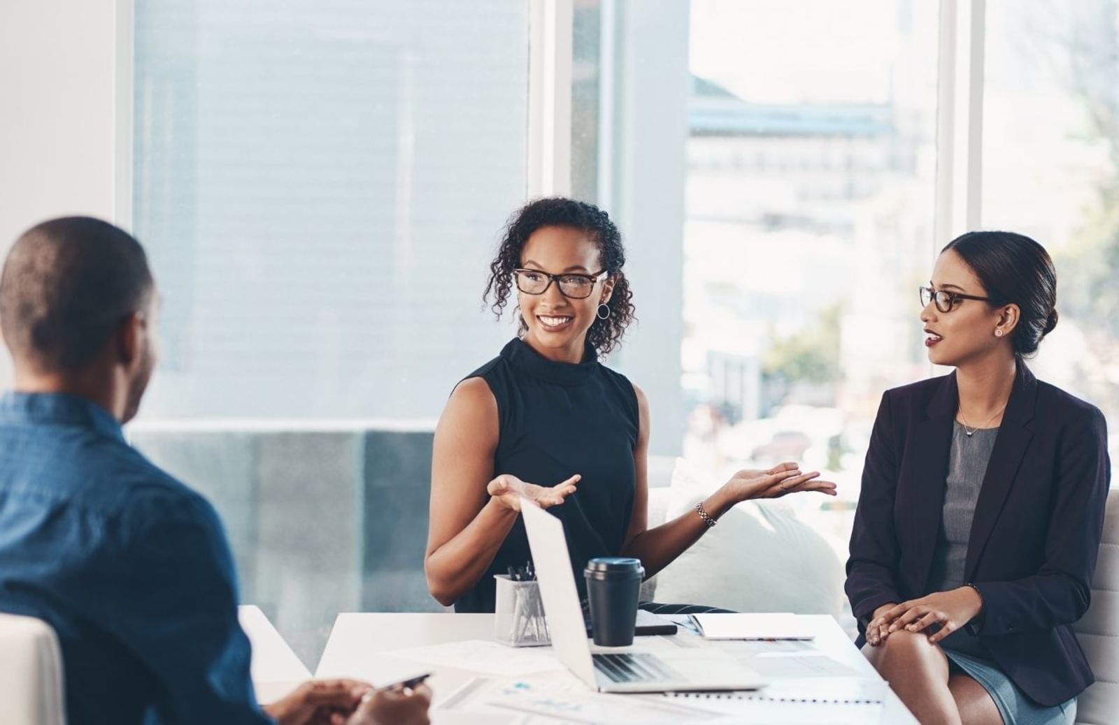 Three business people talking at desk