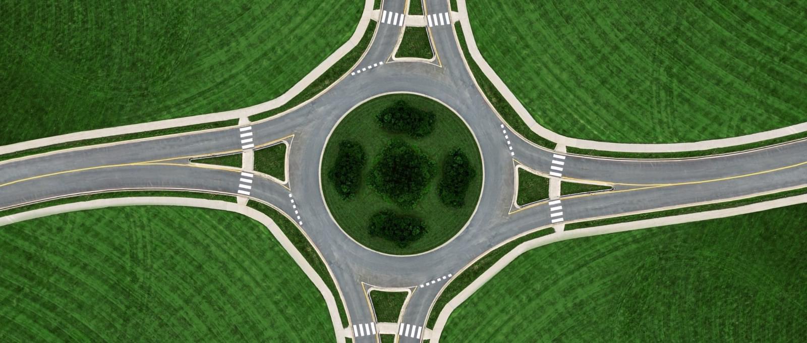 Roundabout with green grass uniquely positioned to bring together our audiences