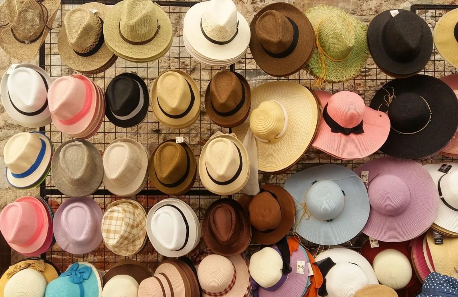 Wall covered with hats in various colors