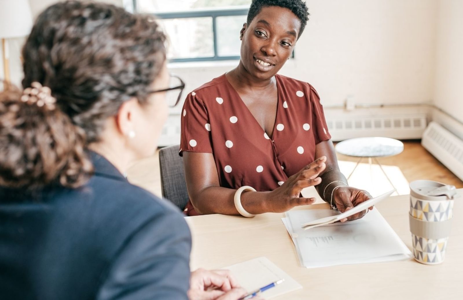 Two women at an interview in an office setting