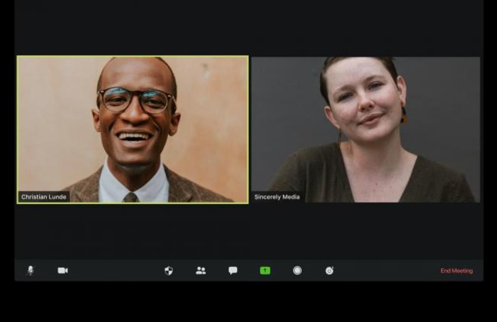 Professional man and woman in different virtual meeting windows on computer screen
