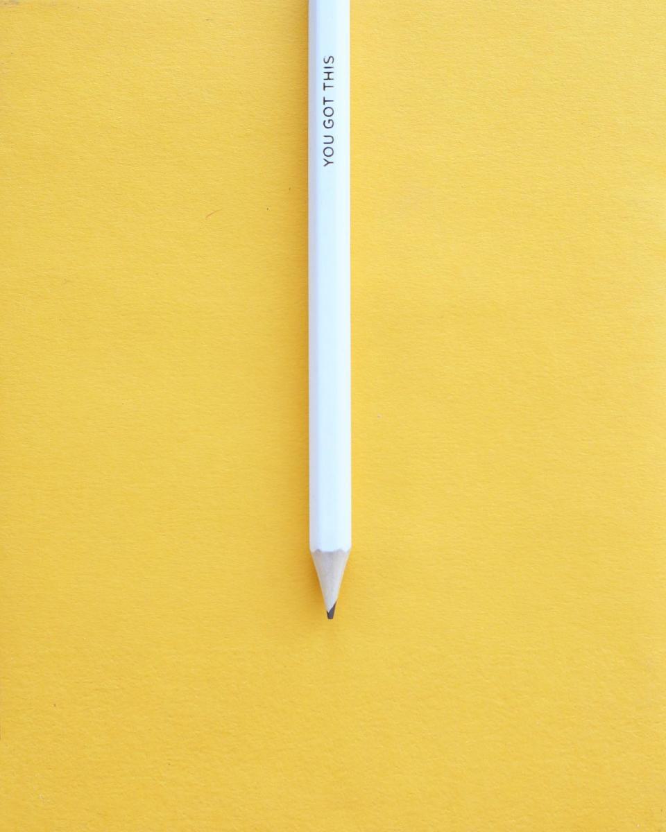 A sharpened white pencil with the words 